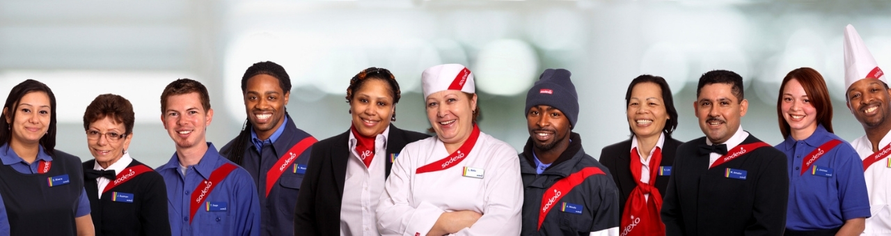 diverse group of sodexo employees wearing uniforms posing for camera